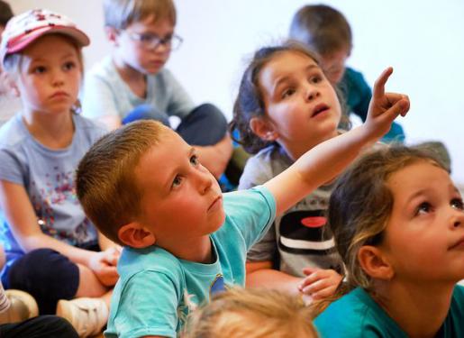 enfant levant la main pour prendre la parole